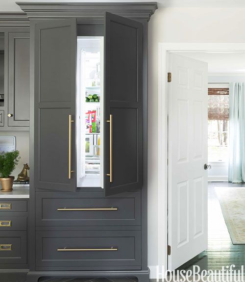Stylish refrigerator disguised as part of kitchen cabinets.