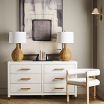 Tailored in crisp white linen upholstery, tri-leg frame, burl wood in light finish and brass ferrule hardware.