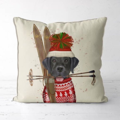 Holiday/Winter pillow featuring a black lab with a tasseled hat and a pair of skis.