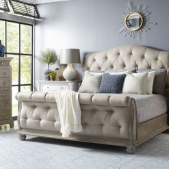 Cottage Tufted Sleigh Bed in a blue room