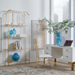 Cosby desk shown sitting in front of a city window with gold etagere.