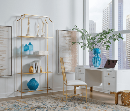 Cosby desk shown sitting in front of a city window with gold etagere.