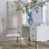 Fresh, white lacquer case floats atop four polished brass legs. Shown sitting in front of a city window.