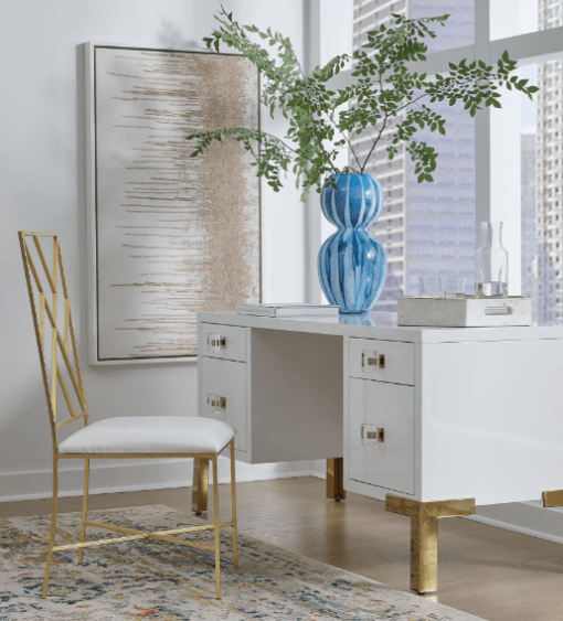 Fresh, white lacquer case floats atop four polished brass legs. Shown sitting in front of a city window.