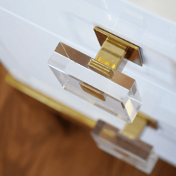Close up of brass and acrylic knob pull.