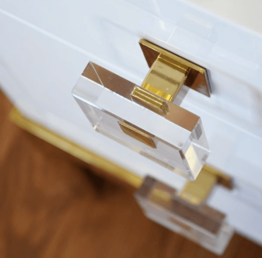 Close up of brass and acrylic knob pull.