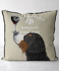 Bernese dog with a glass of red wine balanced on his nose.