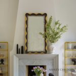 Feminine curves and fanciful scallops are highlighted in gilded gold. A lightly hand antiqued mirror finishes the overall look and makes this design a swoon-worthy addition to any space.