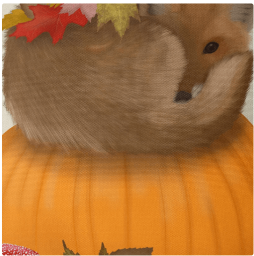 A pillow with a hand painted fox on top of an orange pumpkin.