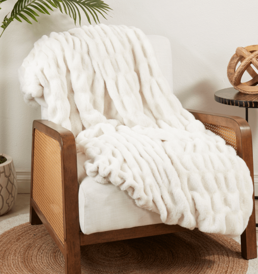 Ivory ruched throw on lounge chair