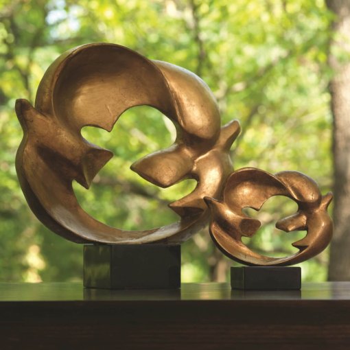 2 doves connected by their wings that forms a circle. Gold leaf finish sits on black granite base.