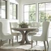 This white oak round dining table shown here with coordinating upholstered chairs.