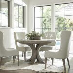 This white oak round dining table shown here with coordinating upholstered chairs.