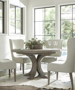 This white oak round dining table shown here with coordinating upholstered chairs.