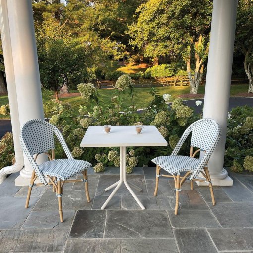 Cafe side chair lifestyle with white and royal blue wicker.