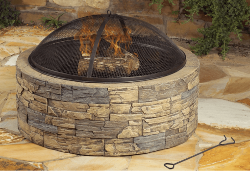 35" cast stone fire pit with fire in bowl lifestyle.