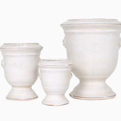 Tuscan planters stacked side by side in a row backside
