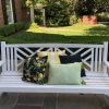Lemons and green woven pillows shown on front porch bench