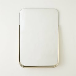 Rectangular mirror with brushed brass shelf front view.